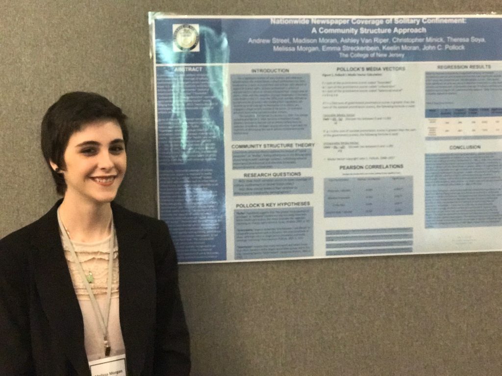 person posing next to chart