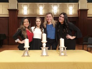 posing in front of table with candles