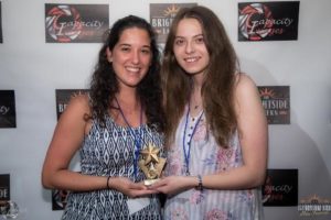 two women holding award