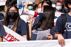 masked students protesting outside